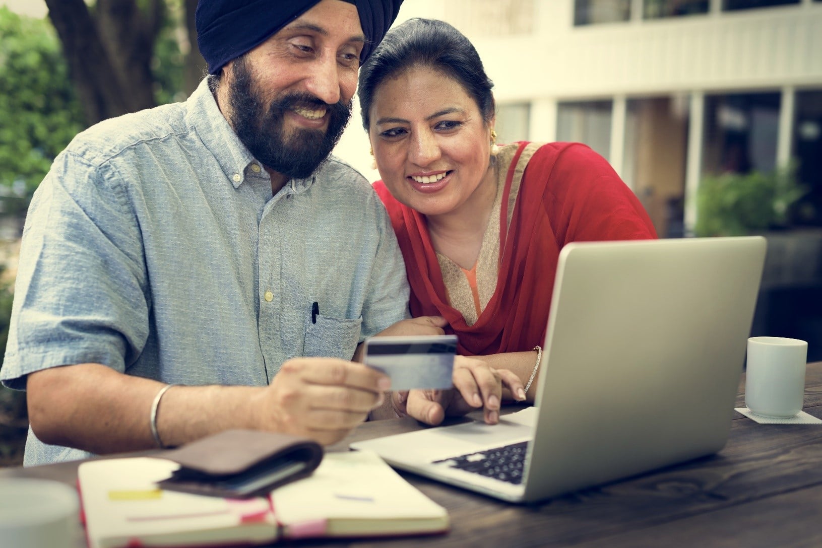 Couple budgeting at a picnic table