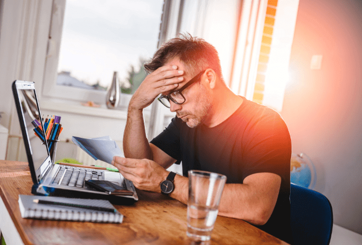 Man looking at a document and feeling worried