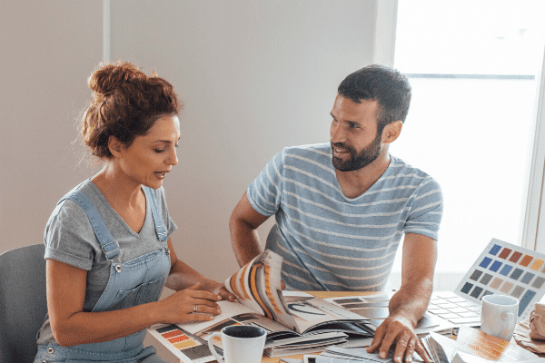 Couple planning a home renovation in front of a table