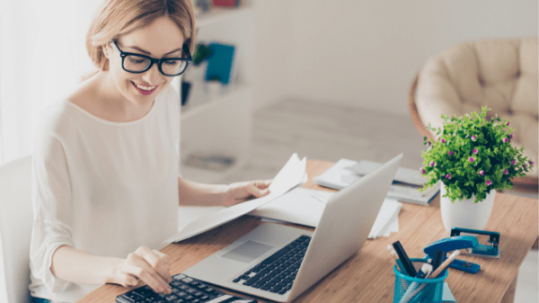 Home owner working with calculator and computer to check if refinancing makes financial sense