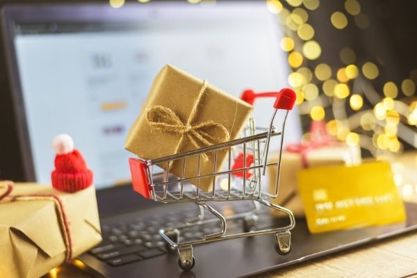 Trolley with Christmas gifts, bank card and laptop