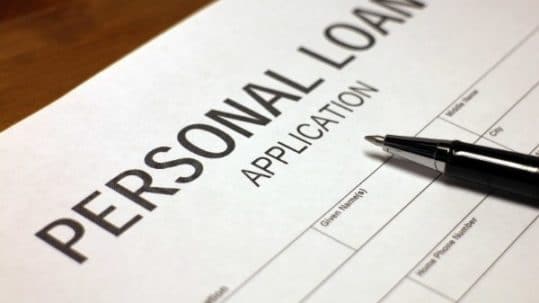 Someone filling out personal loan application