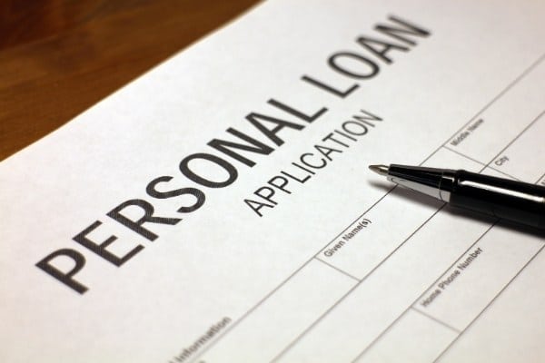 Someone filling out personal loan application