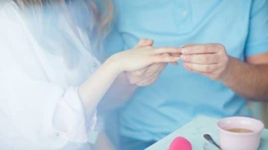 Man making a proposal with the ring to his girlfriend