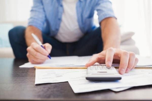 Man figuring out his finances in the living room