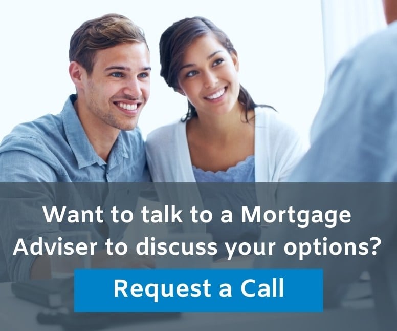 Close up of a young couple talking to a mortgage adviser