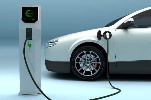A white electric vehicle charging.